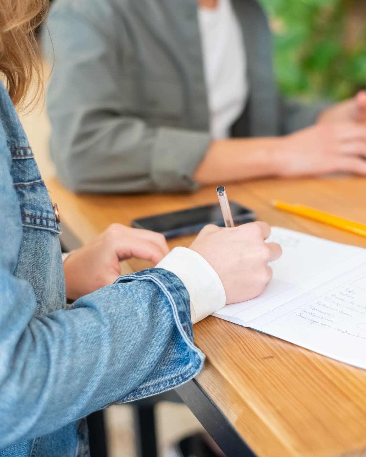 Hands and a notebook during a working session at a table